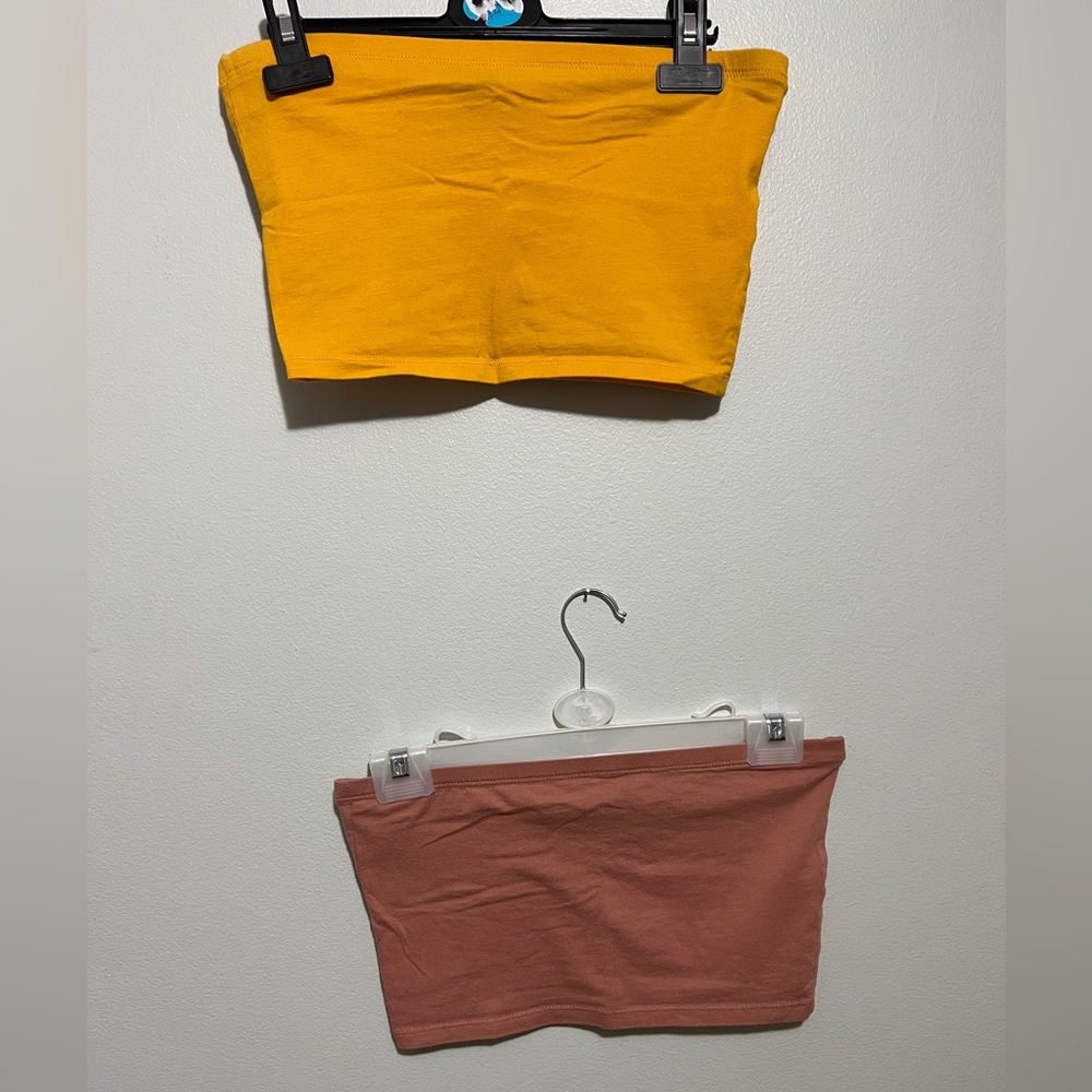 Two strapless tube crop tops size Medium and colors (mustard yellow and pink).
